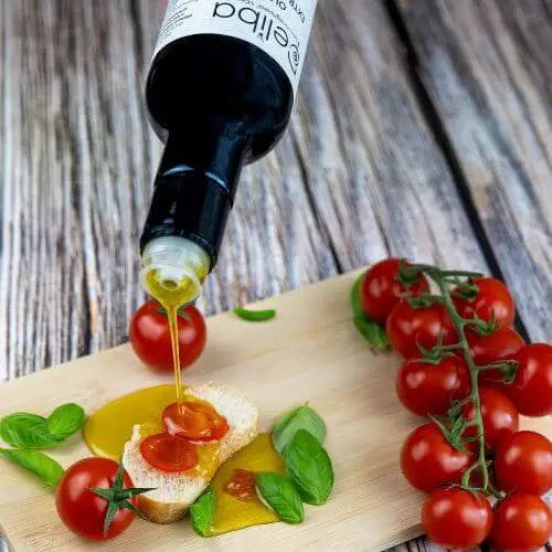 Finishing with Deliba extra virgin olive oil — drizzle on bread for dipping