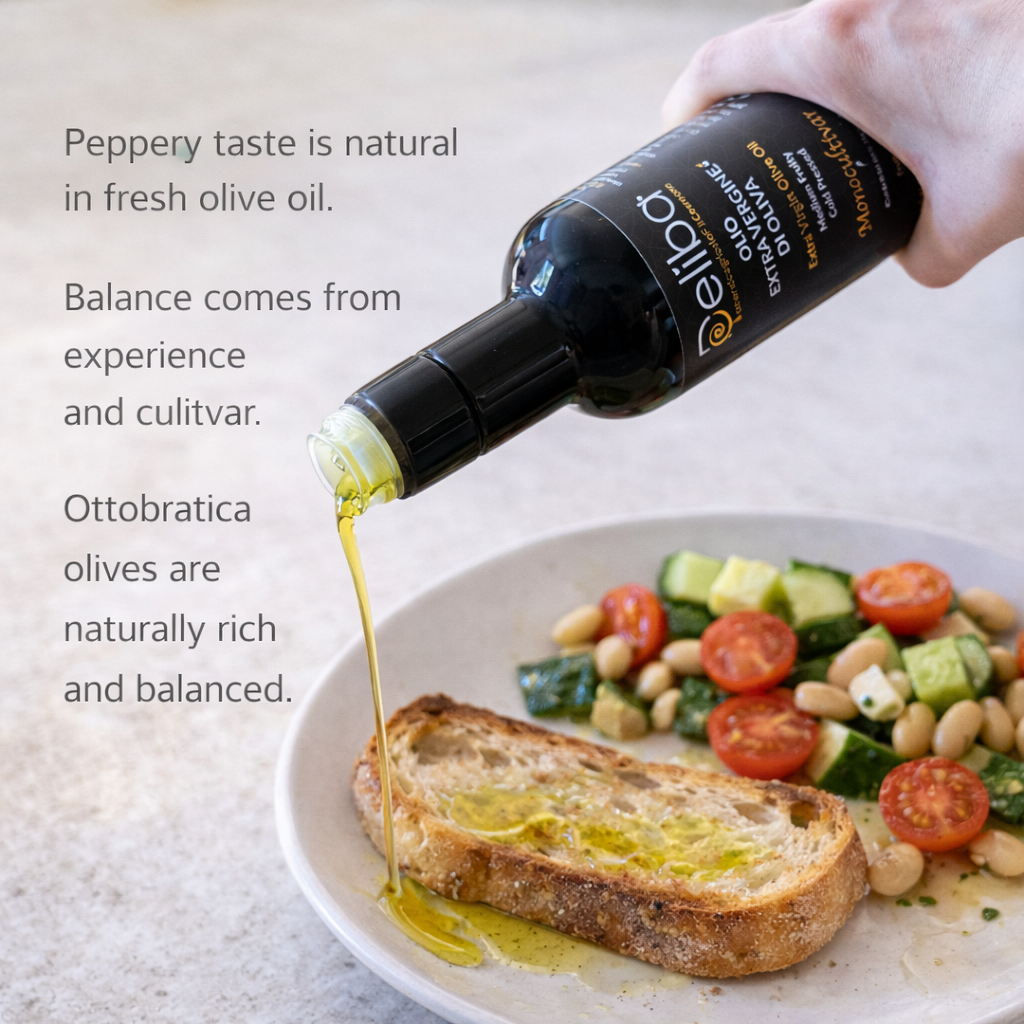 Deliba extra virgin olive oil poured raw on simple food, explaining that a balanced peppery taste depends on cultivar and production experience.